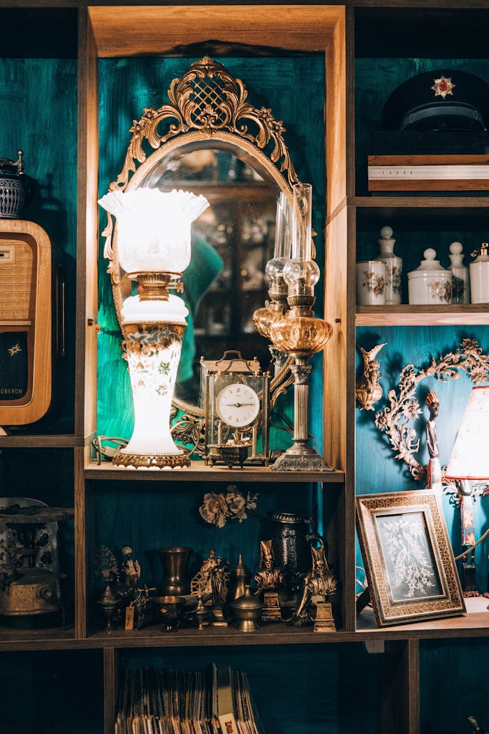 A vintage room with a retro mirror, antique clock, and classic lamps on intricately detailed shelves.